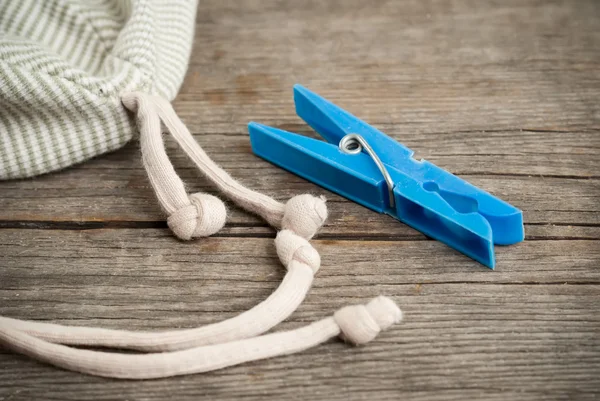 Blue plastic clothespin on the old wooden table — Stock Photo, Image