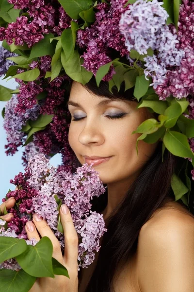 Beautiful woman with lilac flowers