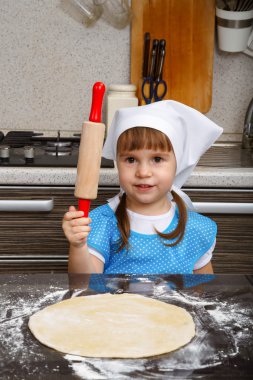 Little girl is playing as a cook clipart