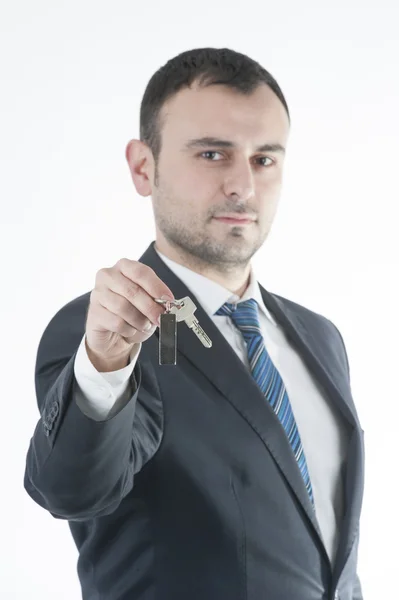 Businessman give metal home key — Stock Photo, Image