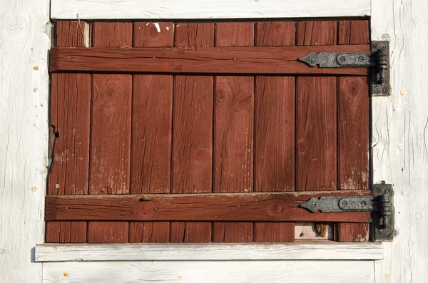 Weathered red plank window shutter — Stock Photo, Image
