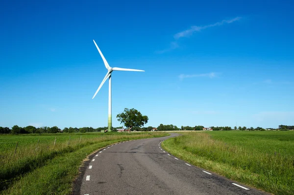 Windmill by a country road side — Stock Photo, Image