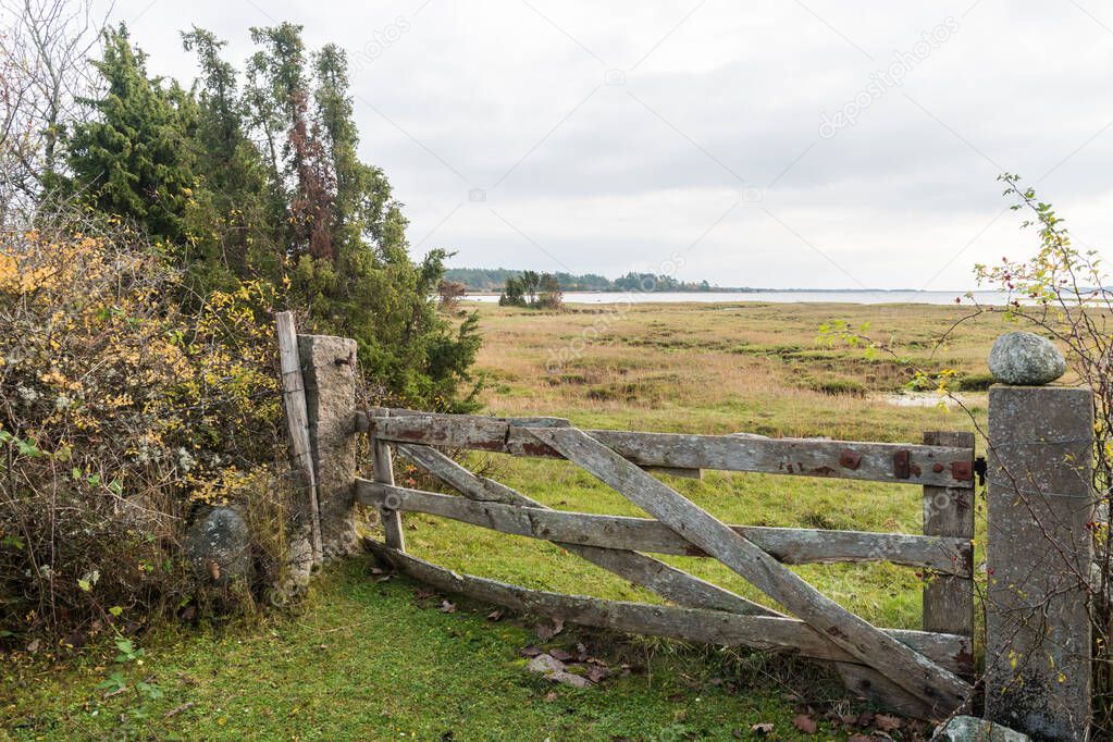 Weathered old wooden gate by the coast of the Baltic Sea on the island Oland in Sweden