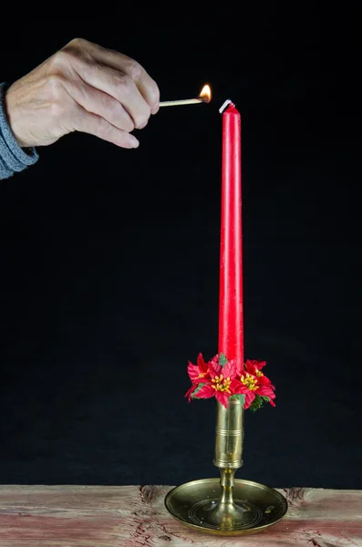 Lighting a christmas candle — Stock Photo, Image