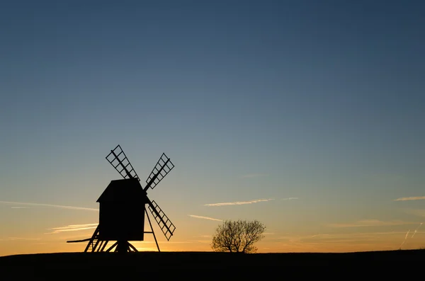 Velha silhueta de moinho de vento ao pôr do sol — Fotografia de Stock