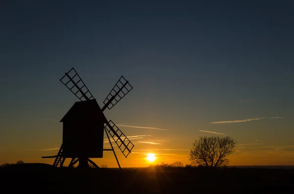 Solnedgang med silhuet af en gammel vindmølle - Stock-foto