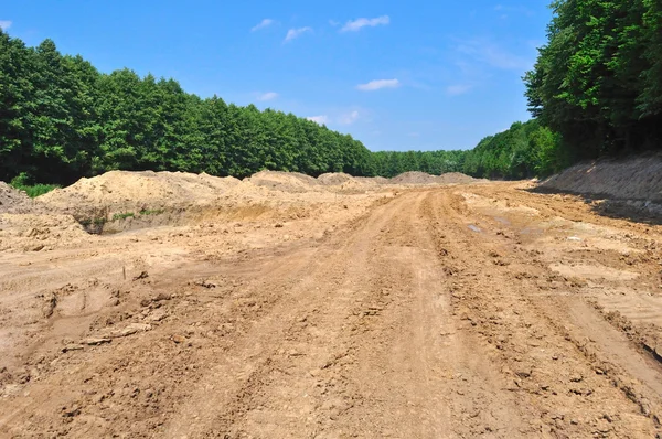 Dirt clay road near trees — Stock Photo, Image