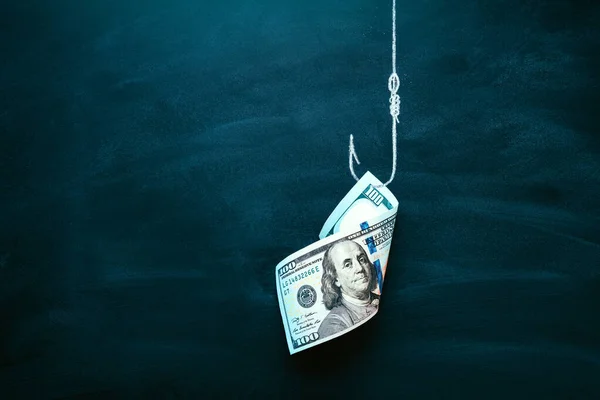 US 100 dollar bill as a bait. American currency on the hook. Investment risk or money trap, business fraud and cheating or financial pitfall and mistake concept. Copy space. — Stock Photo, Image