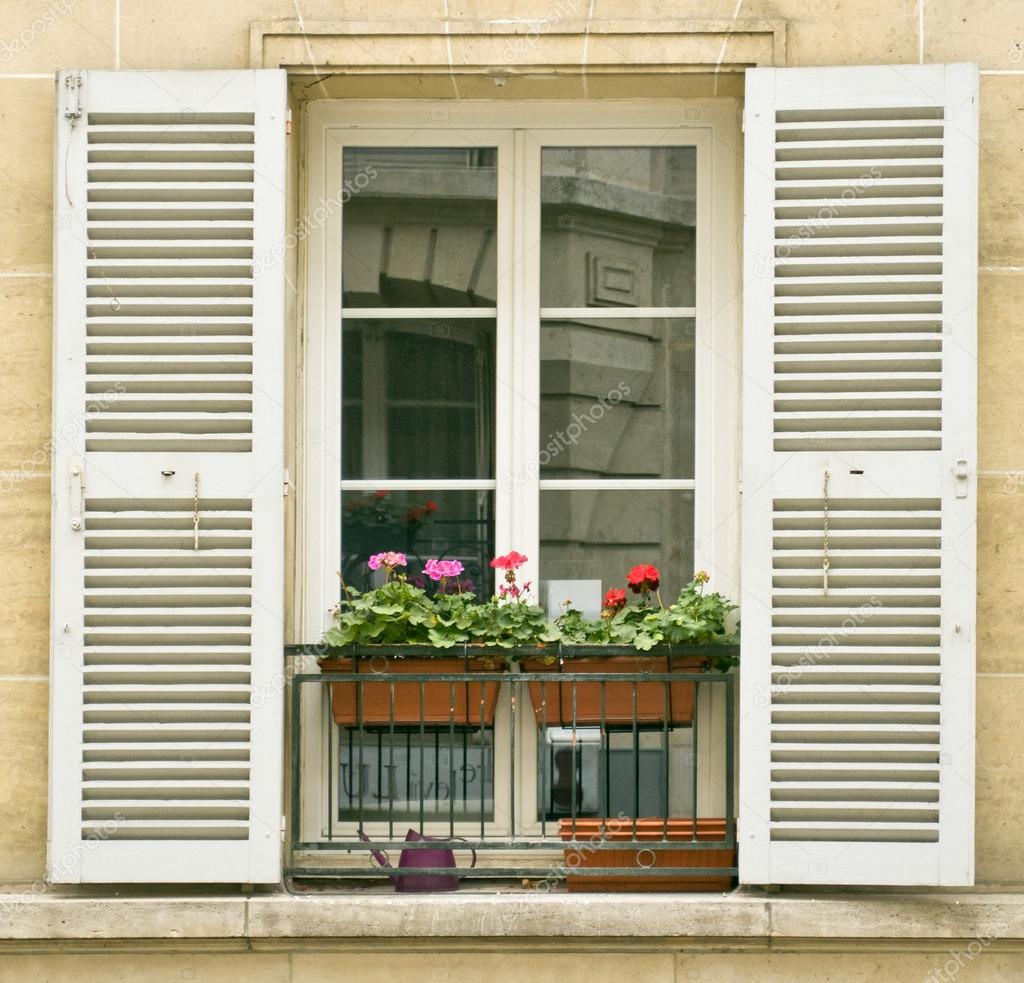 White window with shutters of old buildings on Montmartre, Paris