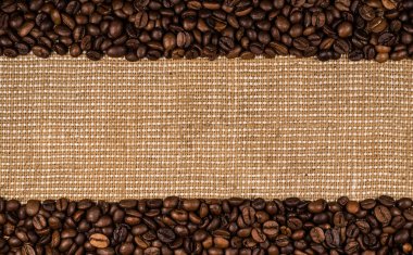 Coffee beans scattered on burlap can be used as background clipart