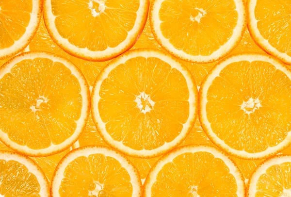 Fundo das muitas fatias de frutas laranja — Fotografia de Stock