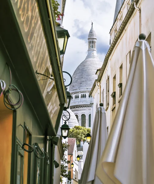 A small alley in Montmartre with the church of Sacre Coeur in ba — Stock Photo, Image