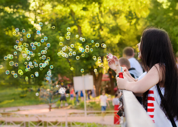 Girl blow bubbles in the flashmob dedicated to Children's Day