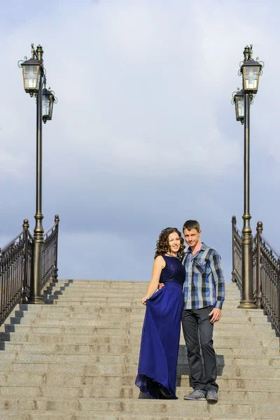 couple in love standing on stone stairs with lanterns