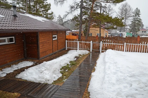 Spring snöblandat i byn. Innergården av lantgårdshus — Stockfoto