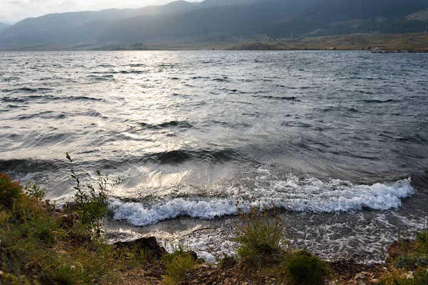 Bad weather on Lake Baikal in evening. Wind and waves in Small Sea strait