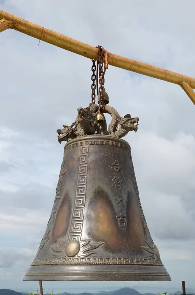 Buddhist bell on a background cloudy sky — Stock Photo, Image