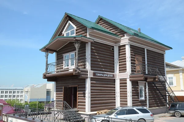 A two-storey log house with wrought-iron balconies — Stock Photo, Image