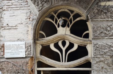 Tbilisi, Georgia-Feb,27 2015:The old front door with wooden ornaments and shattered windows in Tbilisi, Georgia