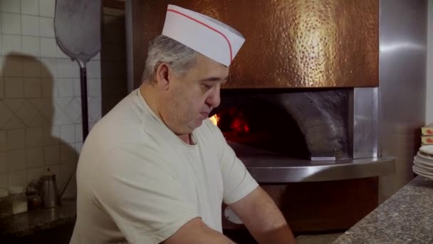 Человек работает повар делает пиццу в итальянском ресторане Кухня Италии — стоковое видео