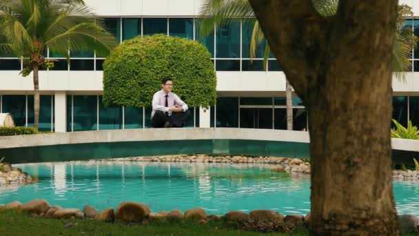 Businessman Meditating Doing Yoga Outside Office Building — Stock Video