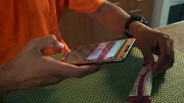 5 Man Athlete Scans Barcode On Protein Bar With Phone — Stock Video