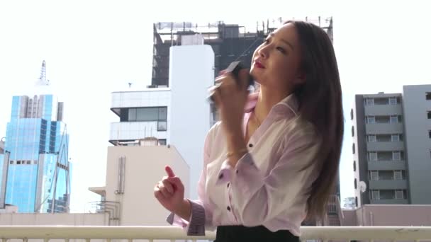 Happy Japanese Asian Businesswoman Talking On Phone Near Office Buildings — Stock Video