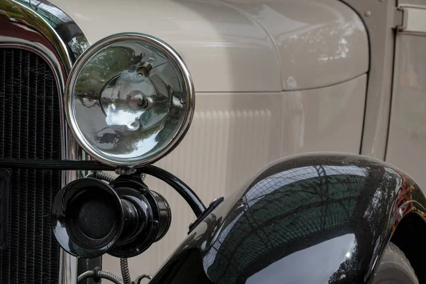 Old retro car lamp. Classic vintage vehicle front. Luxury antique auto with chrome. Automobile headlight detail closeup. American city cab transportation design. Shiny usa oldtimer