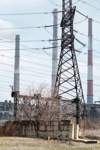 Electric power tower. Electricity transmission network. High voltage station, distribution infrastructure. Electric generation technology , factory sihouette, steel metal lines