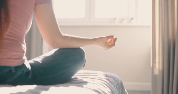 Jonge aantrekkelijke vrouw die 's ochtends oefent in bed in huis. Detail schot handen vrouw zittend in lotus pose yoga meditatie — Stockvideo