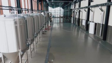 Modern bira fabrikasında parlak metal bira tankları. Geniş açı panoramik görüntü, kamera hareket ediyor