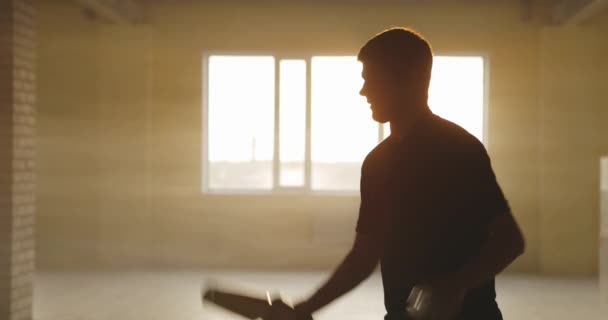 Male bartender juggling bottle and shaker. Barman show, man professional bartender. Warm sun light, slow motion — Stock Video