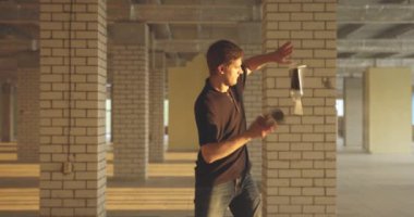 Profesyonel barmen şişe cambazlığı yapar. Barmen, parlak güneş ışığında salonda pratik yapıyor. Yavaş çekim