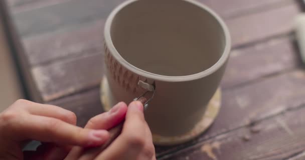 Krukmakaren använder kniv för att dekorera lerskål. Handgjort keramik koncept. Krukskärning. Närbild, slow motion. — Stockvideo