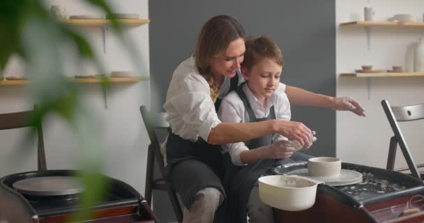 Child boy and his mother on a pottery master class. Happy family concept. Slow motion — Stock Video