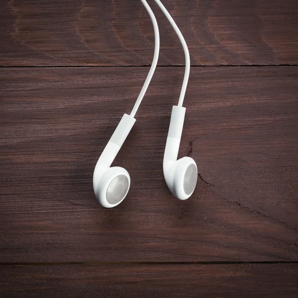 White Earphones on table — Stock Photo, Image