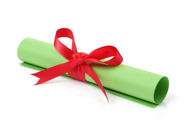 Close up of paper scroll with red ribbon — Stock Photo, Image