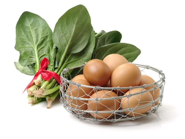 Raw eggs in iron basket — Stock Photo, Image