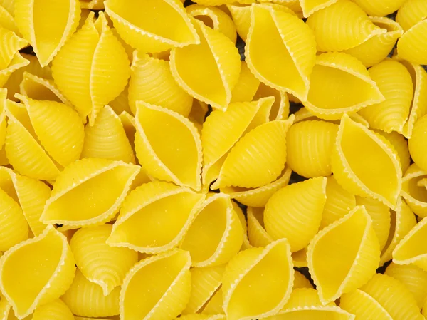 Golden raw pasta in pile — Stock Photo, Image