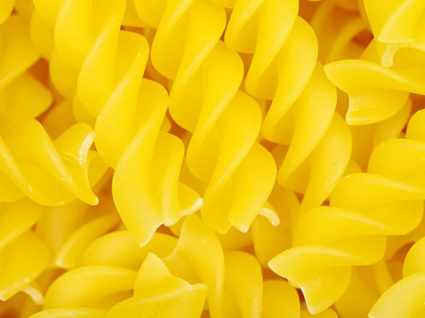 Golden raw pasta in pile — Stock Photo, Image