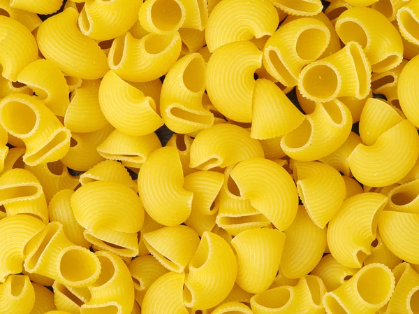 Gouden rauwe pasta in stapel — Stockfoto