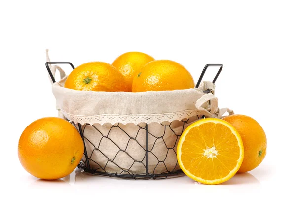 Ripe oranges in iron basket — Stock Photo, Image