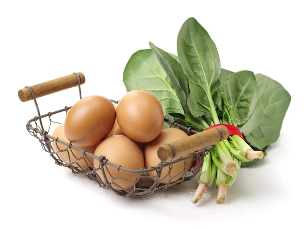 Raw eggs in iron basket — Stock Photo, Image