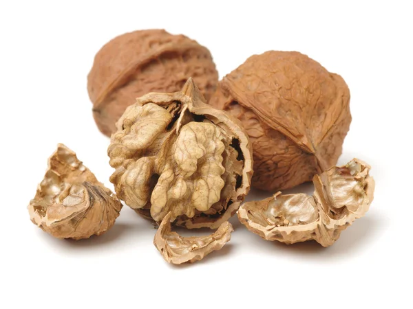 Cracking walnuts on white — Stock Photo, Image