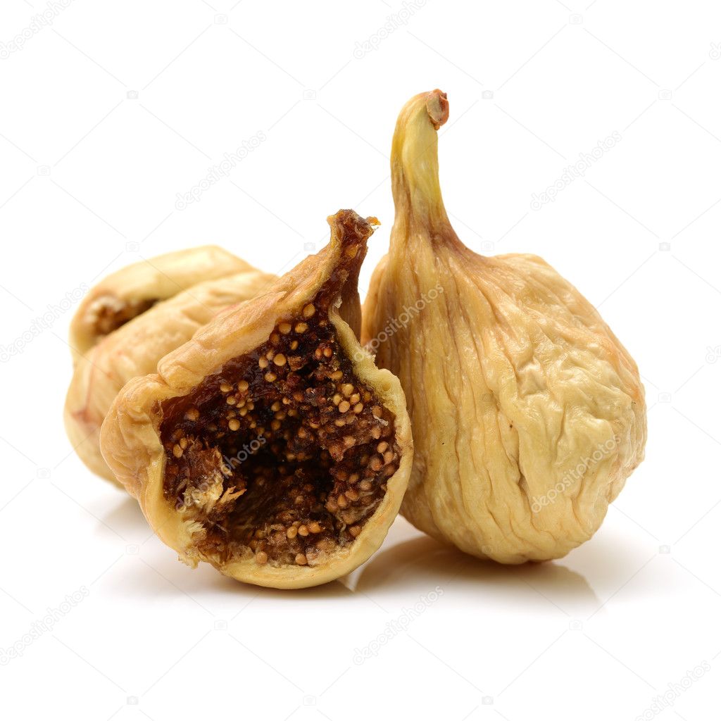 Dried figs with one chopped in half isolated on white