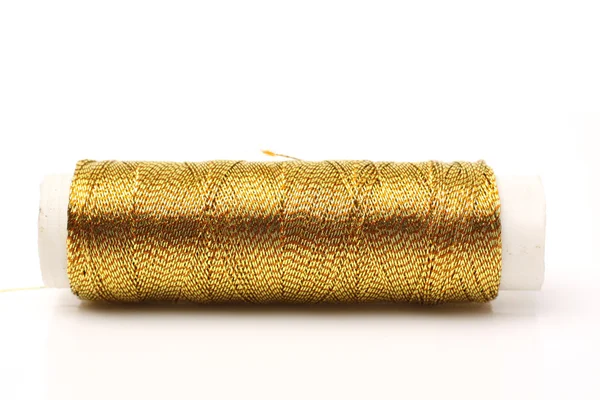 Spool of golden thread — Stock Photo, Image