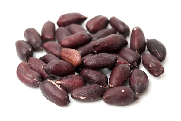 Black peanuts on white — Stock Photo, Image