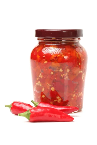 Red chilly and bottled chili sauce — Stock Photo, Image