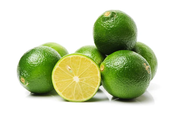 Whole and sliced fresh limes — Stock Photo, Image