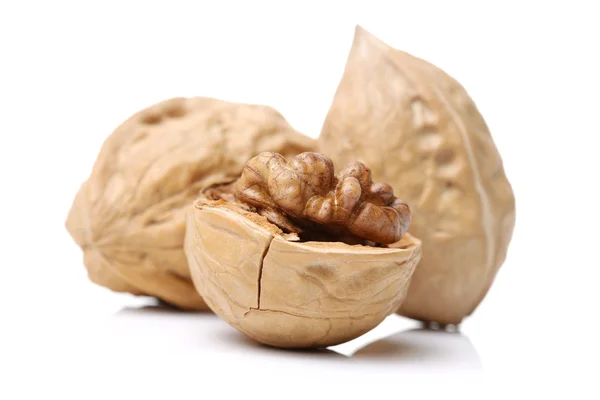 Whole and cracked walnuts with shell — Stock Photo, Image